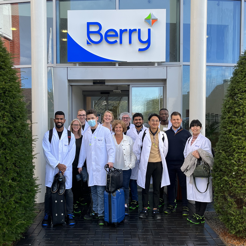 Group of Berry graduates, Berry HR team huddles outside a Berry facility. 
