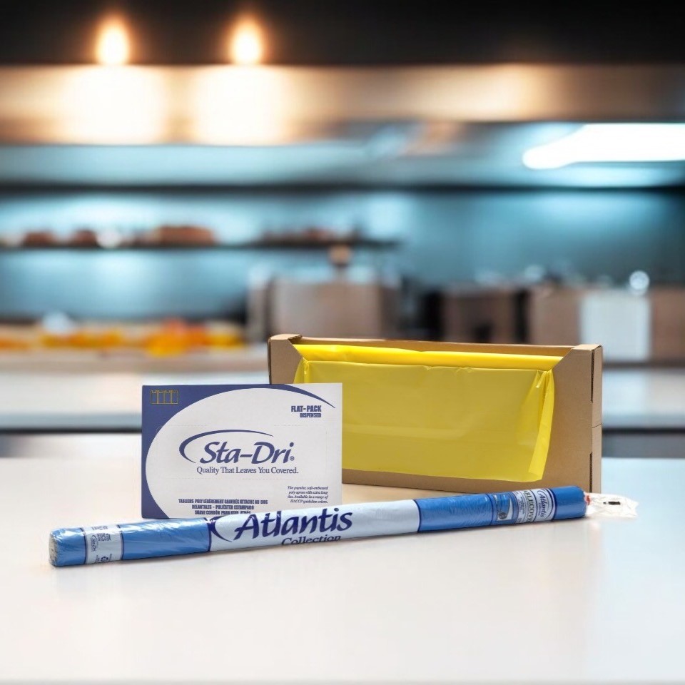Foodservice aprons and tablecloths on an industrial kitchen counter